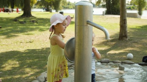  Happy Sweet Children turning Wheel of Head Water Fountain, City Park