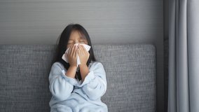 Asian child or kid girl sick and sneezing on nose with cold cough on tissue paper from influenza coronavirus and allergy weak or virus bacteria from PM 2.5 dust weather or smoke at hospital or home 4K - Powered by Shutterstock - Get 15% off with code: PIKWIZARD15