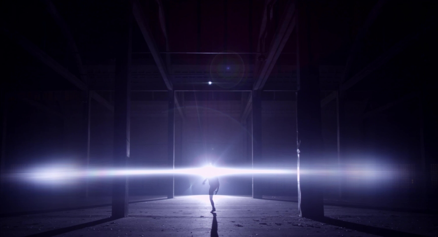 Girl dancing silhouette in large venue