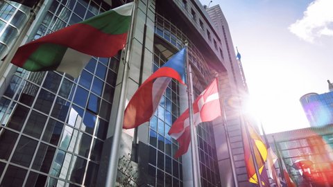Flags of various European countries waving in front of Parliament building, Brussels 4K