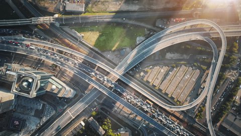 Beautiful aerial timelapse of multi-level highway in Moscow on a sunny evening. Big road junction with a lot of traffic illuminated by the sunset sun.