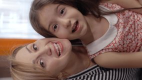 Happy mother and daughter having a video call by mobile phone.Remote communication concept. Video for the vertical story.Front camera view. - Powered by Shutterstock - Get 15% off with code: PIKWIZARD15