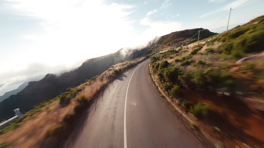 Flying Over Madeira Islands Road. Beautiful Nature of Iceland. Car Driving on the Road to Iceland. Iceland's Main Mountain Road. Cinematic Drone Shot Flying Over Gravel Road at Sunset 4K Footage