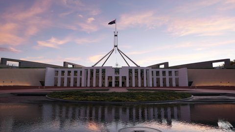 CANBERRA, AUSTRALIA - MARCH, 28, 2021: sunset pan of federal parliament house at canberra in the act, australia