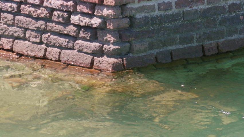 Close up of the bricks coming out of the ocean in the mote area of Fort Jefferson, part of Dry Tortugas National Park in the Florida Keys, 70 miles off the western coast of Key West.