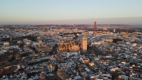 Aerial drone shot of Seville, the capital city of Spain's Andalusia region. Seville is known for its culture, heritage, and being the birthplace of Flamenco. Also seen is the bell tower “La Giralda”