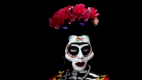 Frida Kahlo skull make up for the day of the dead in mexico. Model with body paint and costume.