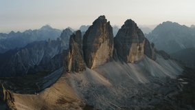 Drone aerial footage of Tre Cime di Lavaredo most visited mountain in Sexten Dolomites Alps in Italy at sunset. Nature alpine park with epic landscape in South Tirol, Europe
