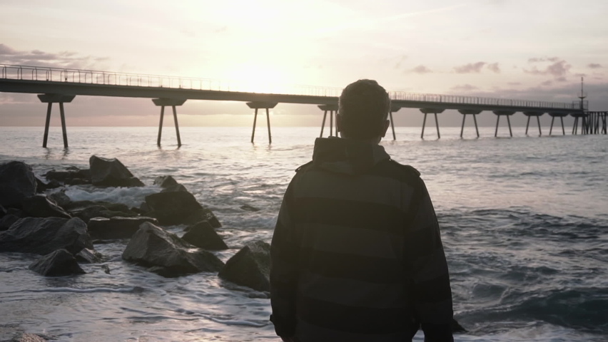 Professional landscape photographer taking pictures at the beach at sunrise.