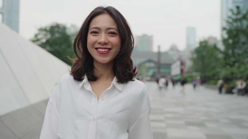 4k slow motion front view of pretty young asian lady walking in the urban street smile at camera real people in the city 4k footage | Shutterstock HD Video #1070621692
