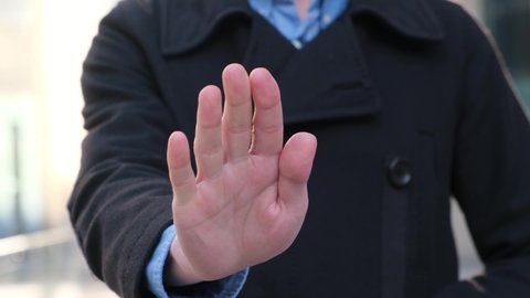 Businessman showing stop sign with hand, close-up