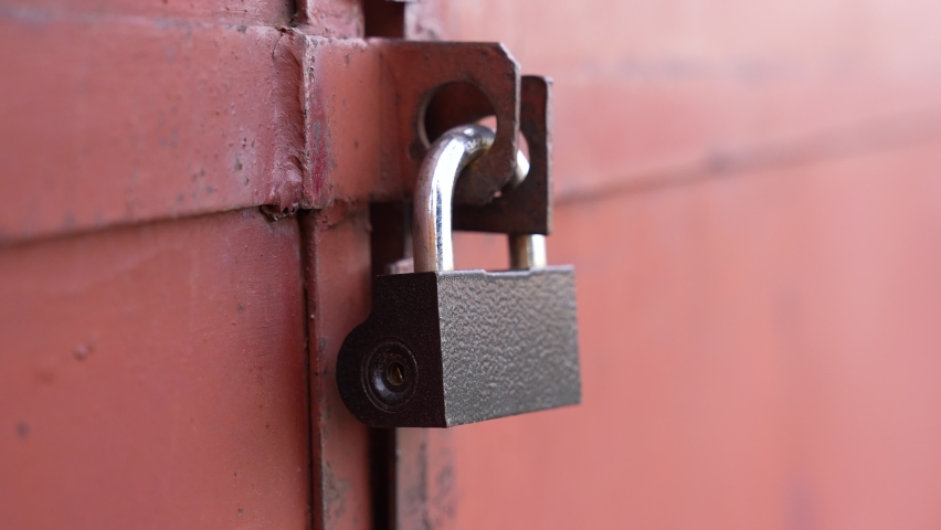 old iron lock on the garage. Vintage a closeup of red old iron lock garage. concept security conservation old house. iron padlock. key password concept closeup