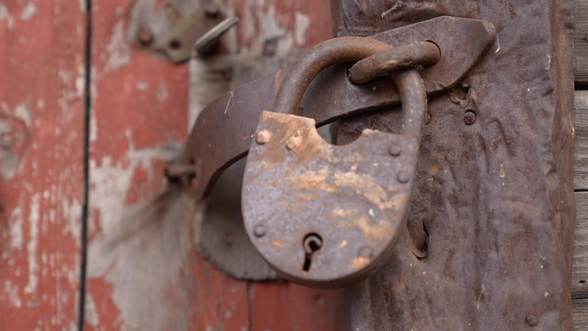 old iron lock on the garage. Vintage a closeup of red old iron lock garage. concept security conservation old closeup house. iron padlock. key password concept