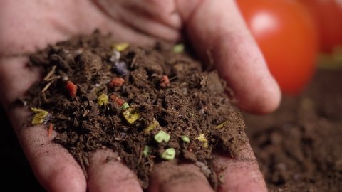 microplastics in soil. plastic waste in agricultural field. soil pollution, agriculture, tiny plastic particles are polluting soil and water, plastic in human hands