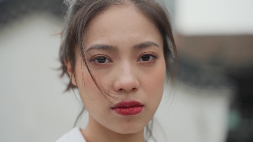 4k slow motion of one beautiful sad asian woman looking at camera tears in the eye unhappy woman portrait hair on the face | Shutterstock HD Video #1070634955