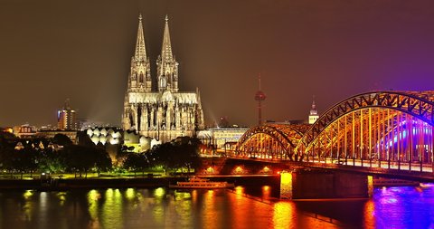 Timelapse of Cologne central cathedral with clouds passing by at river rhine hohenzollern bridge at sunrise shot in 4k