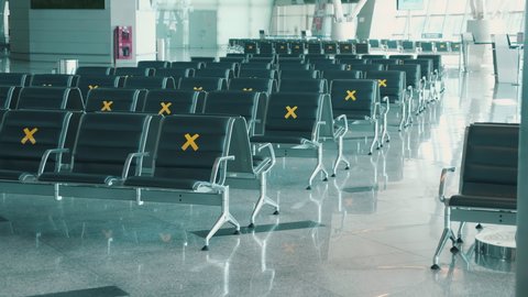 Rows of seats at the airport marked with crosses
