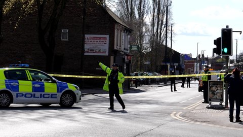 SALFORD, MANCHESTER, UNITED KINGDOM - APRIL, 12, 2021: Section of Liverpool Road and pavement taped off by police because of crime committed inside of the house.