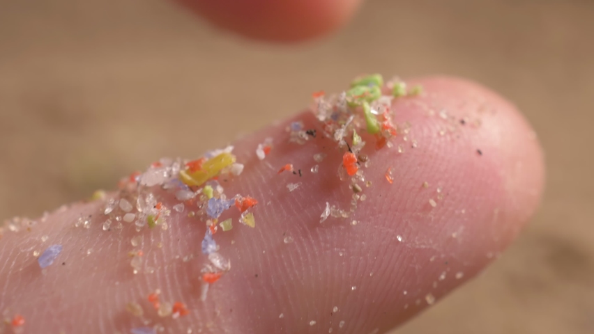 Pieces of microplastic on the finger. primary and secondary microplastics. small plastic pellets in human hands. soil contamination, marine plastic pollution, environment, ecology, earth | Shutterstock HD Video #1070650012