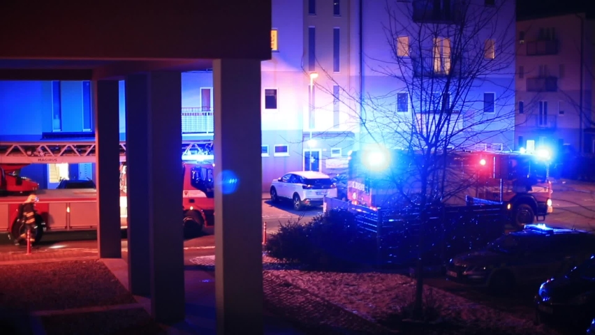 Fire brigade arrived at scene. Flashing lights in courtyard of apartment building in evening residential area Fire safety regulations unexpected law enforcement presence. Establishing Shot residential Royalty-Free Stock Footage #1070658115