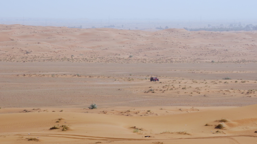 Four-Wheel Landcruiser Driving In Arid Desert During Daytime In Sharjah, United Arab Emirates - Tracking Shot