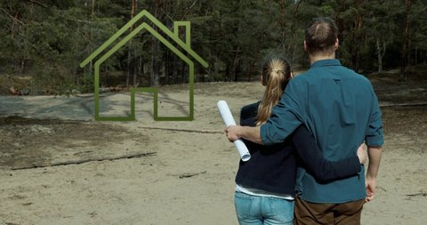 embraced couple standing on purchased building plot of land in forest and planning their dream house