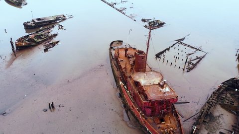 Rotating aerial view of damaged and rusty ship at the ship graveyard. Staten island boat graveyard.