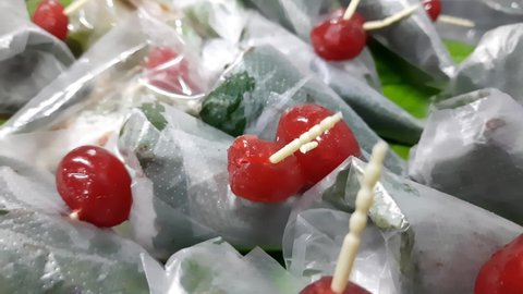 Closeup footage of sweet masala Paan, a preparation combining betel leaf with areca nut, tobacco widely consumed throughout, Southeast Asia, India, and Taiwan as a mouth freshener after a meal.