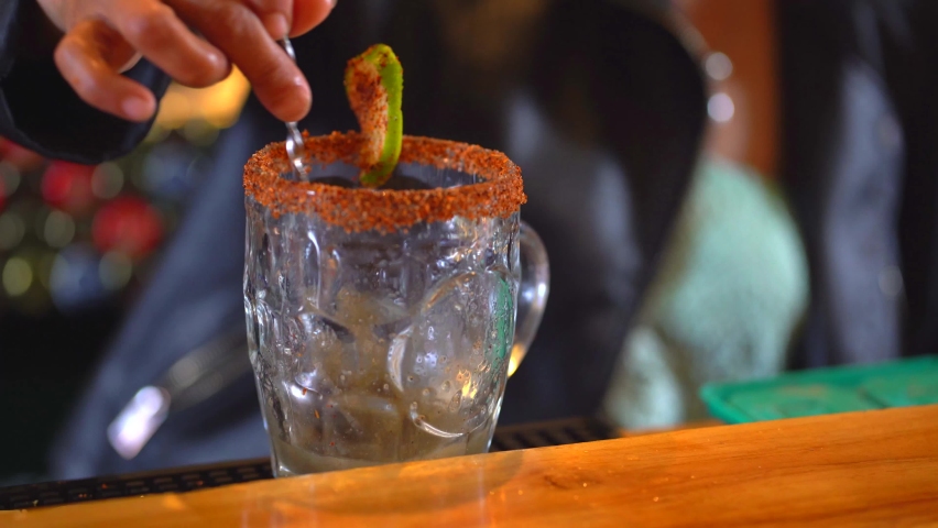 Preparing michelada mix. Bartender preparing drink