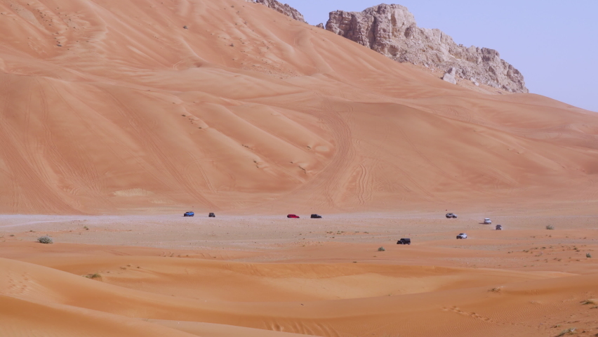Off-Roading Club Enthusiasts During Dune Bashing In Golden Sand Desert Near Fossil Rock In Sharjah, United Arab Emirates - Wide Shot