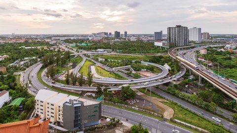 Highway interchange junction and traffic during rush hour at Bangkok outskirt, at evening twilight, day to night, zoom in - time lapse