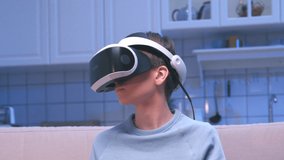 Portrait Boy Uses Virtual Reality Glasses Looking Learning. Facility Helmet for Simulation Application VR. Close-up Teenager Active Watching Eyes Video in Optical VR Headset. Hi-tech Software Industry