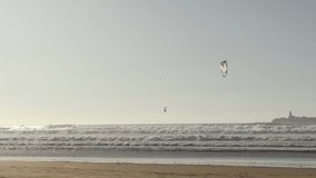 Kiteboarding activity in the waters of Morocco, Essaouira. Kiteboard, surfer, sea, ocean, waves, board, extreme sport, sportsman, summer, vacation  4K Video Footage