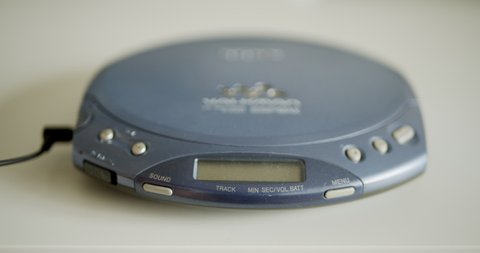 Using vintage cd player discman walkman for music listening with compact disc
