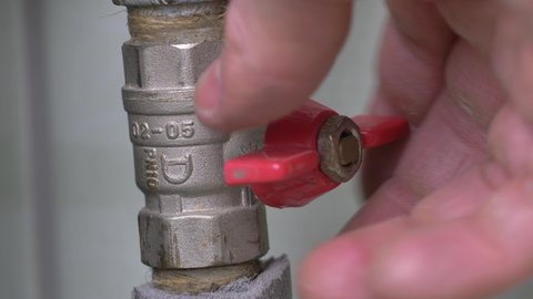 Red Valve being Turned On and Off on Water Pipe