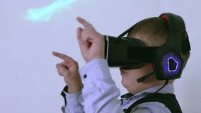 A boy in augmented reality glasses in profile presses virtual buttons. Close-up of a child of Caucasian ethnicity with a vr headset on his head in virtual space on a white background.