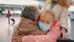 Finally at home. Follow shot of man going at airport building to his meeting him family, embracing with happy kids and wife, tracking shot, slow motion - Powered by Shutterstock - Get 15% off with code: PIKWIZARD15