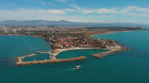 Drone aerial wiew of Side city and harbour in Antalya Turkey. Ruins of Apollon Temple in Side Ancient City. Top view in  beautiful summer day.