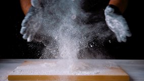 
The cook claps his hands and flour flies to the sides. Explosion of flour. Black background - Powered by Shutterstock - Get 15% off with code: PIKWIZARD15