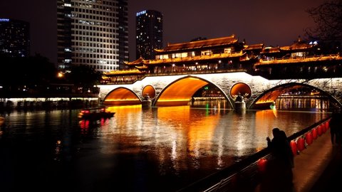 Chengdu,China - April 12, 2021: tourism spot Nine-Eye Bridge shining at night in timelapse.