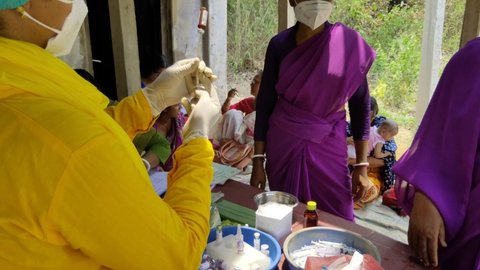 Ghatal,West Bengal,India - April 08, 2021: Pentavalent Vaccination, five antigens - diphtheria, pertussis, tetanus, and hepatitis B and Haemophilus influenzae - Health worker preparing medicine