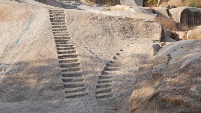 Vertical shot of stairs made on large rock