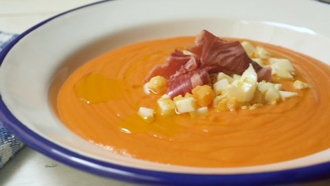 Moving clip from Traditional tapa Salmorejo from south Spain. Cold tomato soup with ham, egg and olive oil.