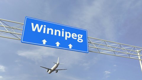 Airplane flies over Winnipeg city road sign