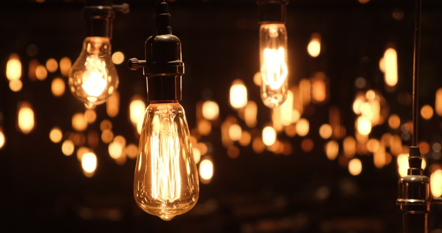 Close up swaying retro light bulb with beautiful bokeh at dark night | Shutterstock HD Video #1070747632