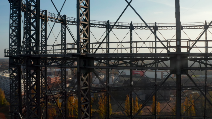 Close up of old abandoned Gas holder or Gasometer in Berlin, Germany with Cityscape in beautiful Autumn Sunset Royalty-Free Stock Footage #1070751031