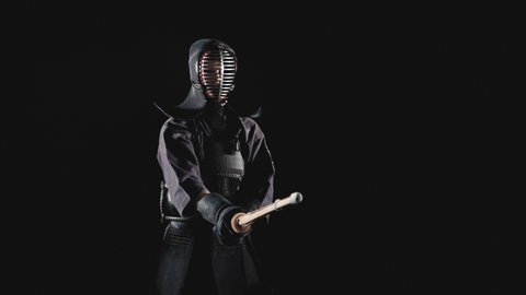 Japanese kendo fighters with with shinai on a black background