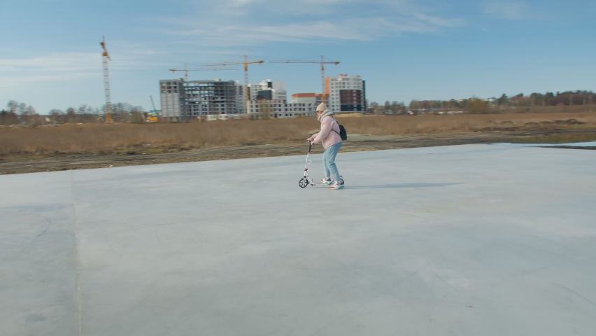 Park kick scooter young woman outdoors