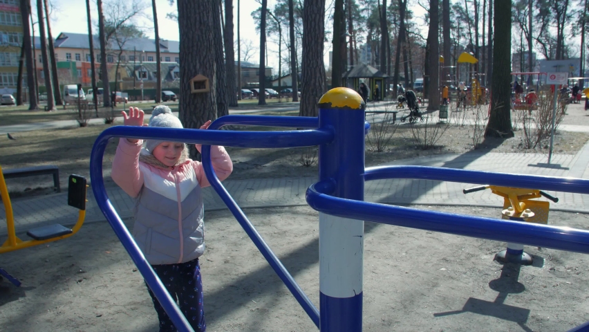 Little girl on sports equipment outdoors in the park