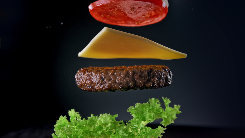 Beef Burger Ingredients Falling and Landing in the Bun One by One in Slow Motion 1000fps | Shutterstock HD Video #1070767552